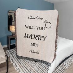 a blanket that says charlotte will you marry me?