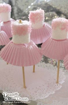 pink and white cupcakes with frosting on them