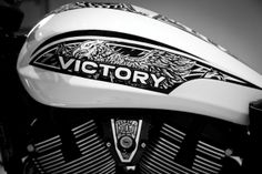 black and white photograph of victory motorcycle with eagle decal on the front fenders