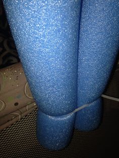 two blue vases sitting next to each other on top of a carpeted floor