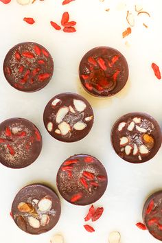 chocolates with red and white sprinkles are arranged on a table