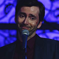 a man standing in front of a microphone