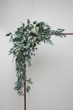 an arrangement of greenery on a wooden pole