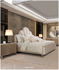 a large white bed sitting inside of a bedroom next to a night stand and two lamps