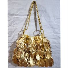 Metallic Gold Leaf Fringe Bucket Chain Purse Never Used, But Due To Being In Storage And Rubbing Against Other Bags, It Has A Lot Of Flaking Of The Faux Leather Around The Top Of The Bag And Some On The Straps. Price Reflects The Flaking Measurements In Photos Super Unique Bag!! Stands Out! Statement Piece Inside Lining Is Pink Outside Faux Leather Gold Leaf-Like Fringed Flaps Chain Strap Can Be Worn As Shoulder, Satchel Or Crossbody Posh Ambassador Fast Shipping Smoke Free And Pet Free Home Chain Purse, Unique Bags, Metallic Gold, Chain Strap, Gold Leaf, Gold Metal, Satchel, Faux Leather, Bag Lady