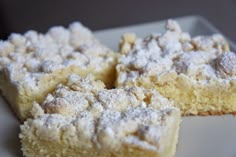 three pieces of cake on a plate with powdered sugar toppings in the middle