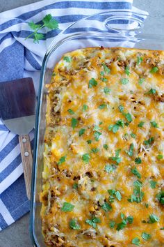 a casserole dish with meat, cheese and cilantro