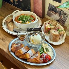 a table topped with plates and bowls filled with different types of food on top of it