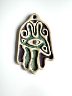 a ceramic hamsa with an eye on it