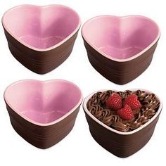 four heart shaped bowls with strawberries in them