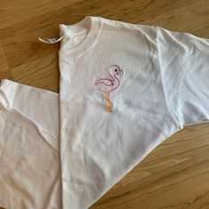 Love This Flamingo Design! Stitched On A White Short Sleeve Youth Medium Tee. I Recently Closed My Embroidery Business And Selling Off All My Sample Shirts. These Are In Great Condition, Brand New! Embroidered With High Quality Thread! Cute White Tops With Machine Embroidery, Cute White Top With Machine Embroidery, Cute White T-shirt With Machine Embroidery, Spring Tops With Custom Embroidery, Cute Pink T-shirt With Machine Embroidery, Cute White T-shirt With Custom Embroidery, White Cute T-shirt With Custom Embroidery, Pink Cotton T-shirt With Machine Embroidery, Pink Crew Neck T-shirt With Machine Embroidery