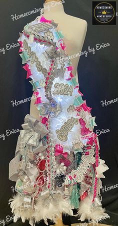 a mannequin made out of different types of buttons and ribbons with words on it