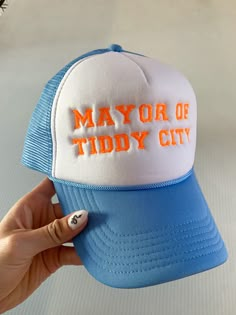 "MAYOR OF TIDDY CITY" FOAM TRUCKER EMBROIDERED HAT Photo features baby blue cap with orange thread Adjustable Hat Size Foam Trucker Hats, Trucker Hat Patch Design, Trendy Trucker Hat, Trendy Trucker Hats For Women, Trucker Hat Funny, Vinyl Trucker Hats, Unhinged Trucker Hats, Embroidered Trucker Hats, Funny Trucker Hats For Women