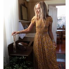 This Dress Is The Sweetest Thing! The Criss Cross Detailing On The Open Back Is So Cute. It Has A Tie On The Waist And You Can Either Tie It In Front Or Back. This Is The Perfect Summer Dress And It Has Pockets! If You Have Any Questions, Please Reach Out! Bohemian Fitted Midi Dress With Ditsy Floral Print, Mustard Fitted Maxi Dress For Vacation, Yellow Short Sleeve Maxi Dress For Garden Party, Mustard Maxi Length Summer Dress, Fitted Mustard Dress For Beach, Yellow Bohemian Maxi Dress With Short Sleeves, Mustard Sundress In Maxi Length, Yellow Bohemian Short Sleeve Maxi Dress, Yellow Bohemian Midi Dress With Short Sleeves