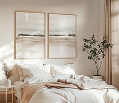 a bedroom with two paintings hanging on the wall