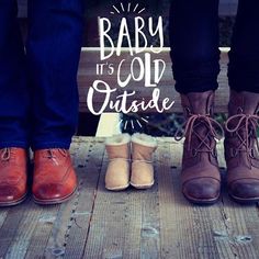 three people standing next to each other on a wooden platform with the words baby it's cold outside