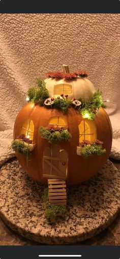 a pumpkin shaped house on top of a table