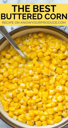 a bowl filled with corn on top of a blue and white towel next to a spoon