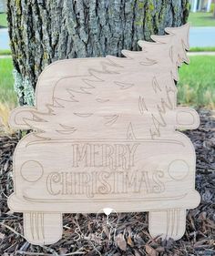 a wooden sign that says merry christmas with a horse on it next to a tree