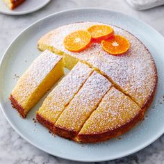 an orange cake with slices cut out on a plate