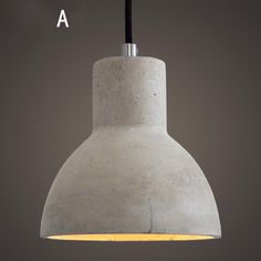 a concrete pendant light with a black cord hanging from it's end and the word, a above it