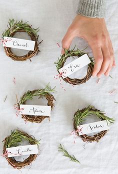 someone is placing their name tags on some wreaths