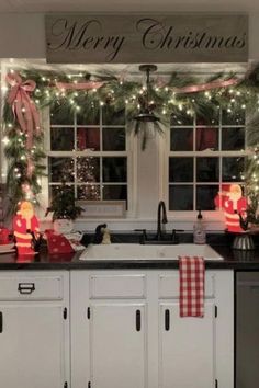 a kitchen decorated for christmas with lights and decorations