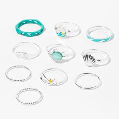 Embrace a warm-weather vibe with this mixed set of rings! Set of 10 includes silver-tone and faux turquoise rings embellished with the images of summer, including a sun, waves, seashells, turtle, and more. Pack Size: 10 Finish: Mixed metal Size: Assorted Material: Metal - Claire's Assorted Silver & Turquoise Summer Camp Rings (10 Pack) Summer Beach Midi Rings, Trendy Stackable Summer Jewelry, Trendy Summer Stackable Jewelry, Summer Beach Jewelry Ring, Beach Summer Jewelry Ring, Summer Beach Ring Jewelry, Trendy Adjustable Midi Rings For Summer, Adjustable Midi Rings For Summer, Summer Beach Stackable Jewelry