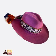 Handmade Felt Fedora Hat. This Violet hat is crafted from sustainable fibers. Our hats are made from 100% felted sheep wool, ensuring softness, comfort, and durability. They are meticulously handcrafted and feature a handwoven band made from sheep and alpaca wool with Andean motifs, adding a unique, artisanal touch to each piece. Your Perfect Adventure Companion! Whether you're traveling, exploring the outdoors, or simply looking to enhance your casual or bohemian style, this hat is the perfect accessory. Details: - 100% Felted Wool: Soft, lightweight, and comfortable. - Handwoven Band: Included with each hat, offering a unique, artisanal look. - Ethically Made in Peru: Proudly crafted by skilled Peruvian artisans, following ethical practices. 📏 Sizes: -  XS: 54 cm | S: 56 cm -  M: 58 cm Traditional Handmade Fedora With Short Brim, Traditional Handmade Wide Brim Fedora, Traditional Fedora For Festivals, Purple Wide Brim Hat For Festival, Traditional Flat Brim Fedora For Festivals, Purple Wide Brim Festival Hat, Traditional Wide Brim Fedora For Festivals, Traditional Brimmed Panama Hat For Festival, Traditional Fedora Hat For Festivals