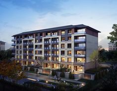 an artist's rendering of the exterior of a modern apartment building at dusk with lights on