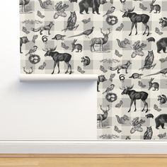 an animal themed wallpaper with black and white images on the wall next to it