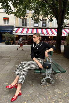 @elodieromy is wearing the Martin crop trousers in gingham. She styles this with red Mary Janes and a black cardigan. Shop the Martin trousers and recreate this look online now at sezane.com Fall Parisian Style, Rich Girl Style, Red Mary Janes, Mary Janes Outfit, Cropped Pants Outfit, Parisian Style Outfit, Gingham Outfit, Brown Gingham, Outfit Office