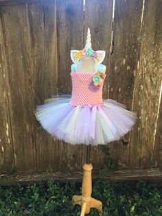 Please read shop announcement for current processing times and updates. Your little girl will look absolutely adorable in this pastel Unicorn tutu dress costume which Includes matching headband with 5 inch horn and a tail. Perfect gift for the girl who loves dress up, a Halloween party, trick or treating, photo shoot, holiday event or any occasion. This tutu dress is made up of 2 full layers of tulle in white, pink, yellow, aqua and lavender. It is attached to the bodice and embellished with flo Girls Unicorn Costume, Unicorn Tutu Dress, Girl Unicorn Costume, Tutu Dress Costumes, Dress Pastel, Unicorn Costume, Girls Halloween, Pink Unicorn, Halloween Costumes For Girls