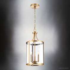 a light fixture with three lights hanging from it's side, against a gray background