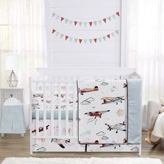 a baby crib bedding set with airplanes and clouds