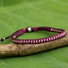 This chic bracelet presented by Napapat is inspired by the Hill Tribe artisans of Thailand. She hand braids deep maroon and vibrant magenta polyester cords to form this braided bracelet with silver beaded accents. It features a sliding knot for easy adjustment. Family Bracelets, Deep Maroon, Chic Bracelet, Silver Bead Necklace, Braided Bracelet, Silver Charm Bracelet, Cord Bracelets, Artisan Craft, Silver Accents