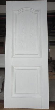 an open white door in the middle of a room