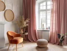 a living room with pink curtains and furniture