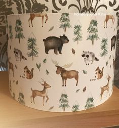 a lampshade with animals and trees on it