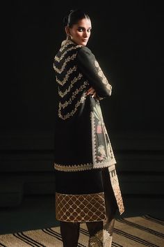 Black straight kurta with patchwork jaal embroidery across the hem, with gul jharokha motif embroidery in gold tones. Paired with a salwar with gold motif embroidery. Comes along with a jacket with berry bel motif embroidery in gold tones using sequins. - Aza Fashions Ceremonial Anarkali Bandhgala For Transitional Season, Traditional Silk Nehru Jacket With Dupatta, Traditional Chanderi Outerwear For Designer Wear, Silk Long Sleeve Sherwani For Navratri, Traditional Silk Outerwear With Traditional Drape, Anarkali Bandhgala With Dabka For Navratri, Traditional Silk Nehru Jacket, Fitted Black Kurta With Gold Embroidery, Semi-stitched Black Dupatta With Dabka Detailing