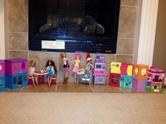 there are many dolls sitting in front of the tv