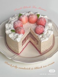 there is a cake with white frosting and strawberries on the top, sitting on a plate