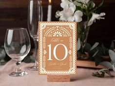 a table with place cards and wine glasses