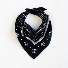 a black bandana with white polka dots on it