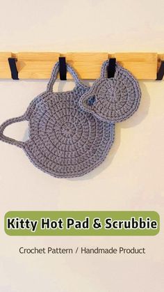 two crochet potholders hanging on a hook with the text kitty hot pad & scrubbie