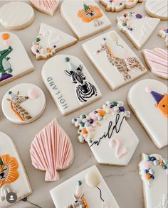 many decorated cookies are displayed on a table