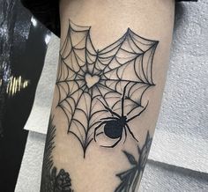 a spider web tattoo on the leg