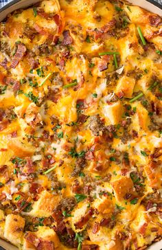 a casserole dish with sausage, cheese and other toppings in a pan