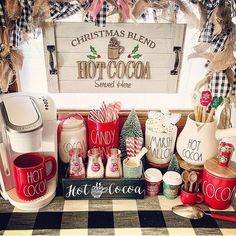 a coffee bar with hot cocoa and candy canes on the counter next to a christmas sign