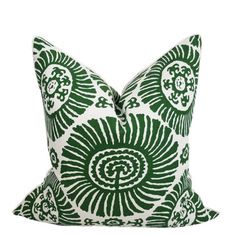 a green and white pillow with an intricate design on the front, sitting on a white background